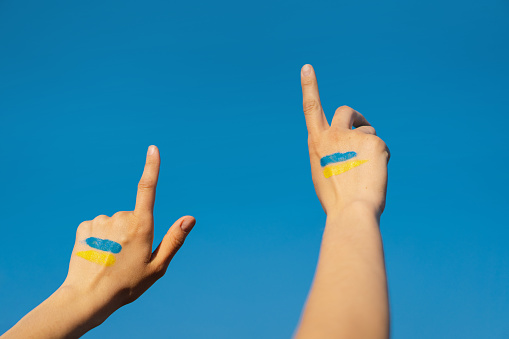 Cheerful ukrainian girl that shows a sign of thumb up sign.