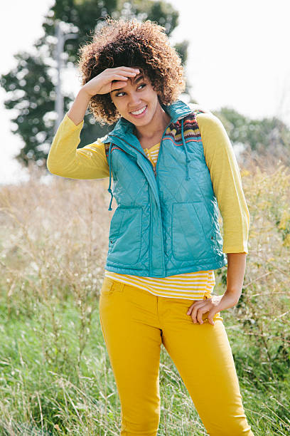 Cheerful woman wearing a vest Cheerful college student wearing warm clothing. Back to school hot puerto rican woman stock pictures, royalty-free photos & images