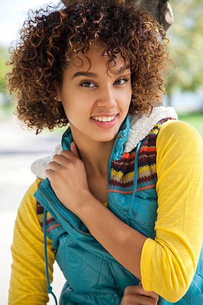Cheerful woman wearing warm clothing Cheerful college student wearing warm clothing. Back to school hot puerto rican woman stock pictures, royalty-free photos & images