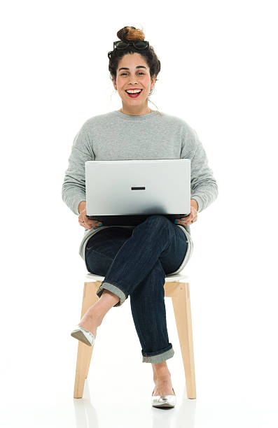 Cheerful woman working on laptop stock photo