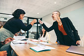istock Cheery businesswomen fist bumping each other before a meeting 1348871728