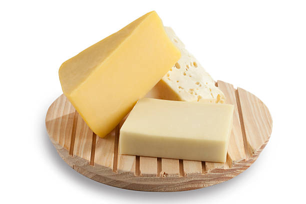 Cheese blocks on a cutting board stock photo