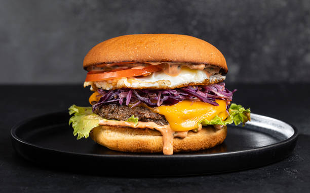 Cheese burger with bacon on black dark background stock photo