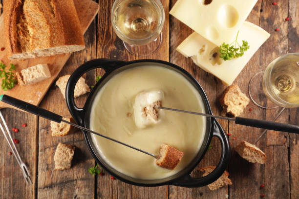 cheese fondue with bread and wine stock photo