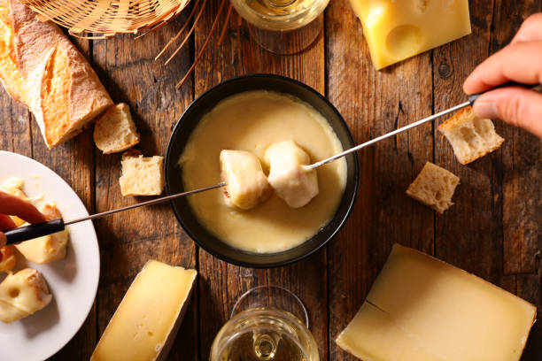 cheese fondue with bread and wine stock photo