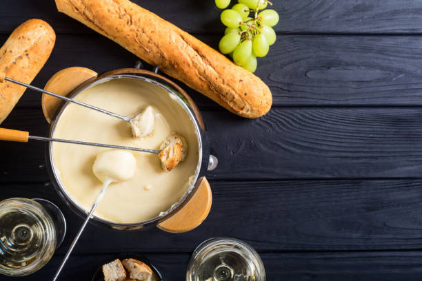 Cheese fondue with bread wine and grape stock photo