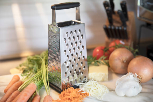 Cheese Grater and Vegetables stock photo