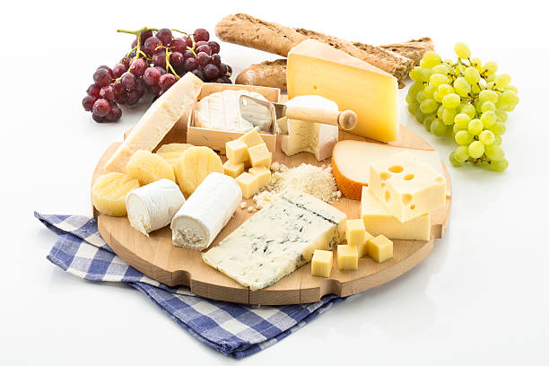 Cheese platter with different cheese and grapes stock photo