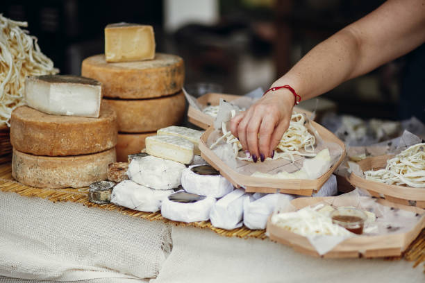 Cheese set on stand at street food festival in city. Different types of cheese, brie, blue,gorgonzola,goat, parmezan on wooden table.Street food festival stock photo