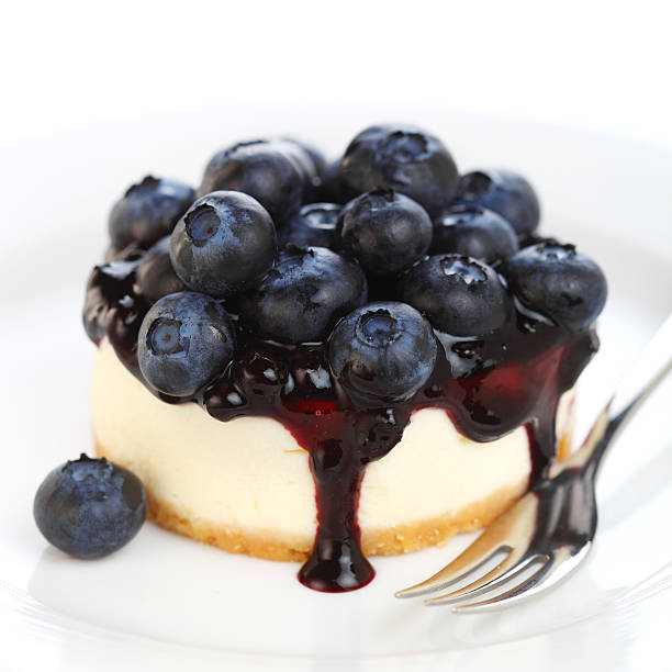 Cheesecake with fresh blueberries on white isolated background stock photo