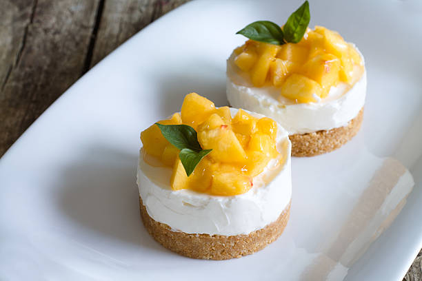cheesecake with peaches on wooden background. - crumble stok fotoğraflar ve resimler