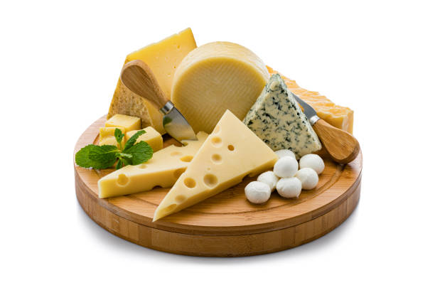 Cheeses board isolated on white background Wooden board with a variety of cheeses isolated on white background. Cheeses included in the composition are Manchego cheese, goat cheese, emmental cheese, Roquefort cheese, mozzarella cheese and Cheddar cheese. Predominant colors are yellow and white. High resolution 42Mp studio digital capture taken with Sony A7rii and Sony FE 90mm f2.8 macro G OSS lens cheese stock pictures, royalty-free photos & images