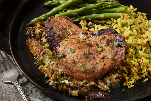 Cheesy Spinach Stuffed Pork Chops with Asparagus and Wild Rice