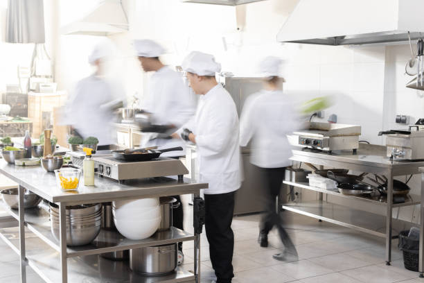 Chef cooks working in professional kitchen stock photo