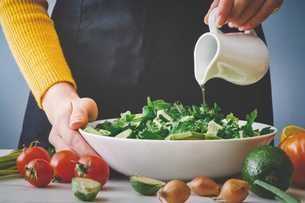 Chef pouring salad oil stock photo
