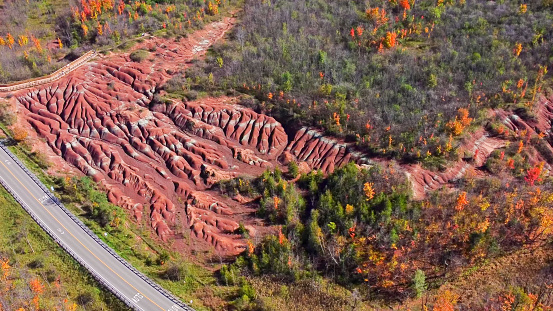 Cheltenham Badlands are in Caledon, Ontario, on the south east side of Olde Base Line Road, between Creditview and Chinguacousy Roads.
