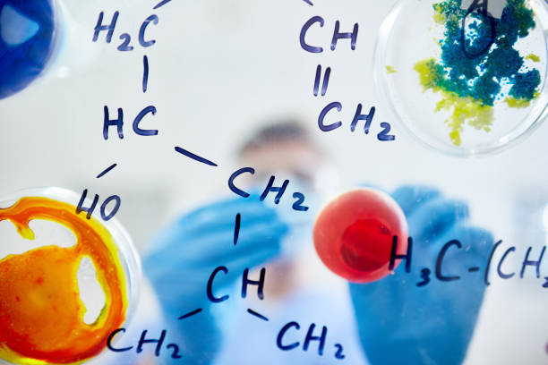Chemical formulas with various substances Close-up of glassy board with chemical molecular formulas and colorful substances in petri dishes chemical reaction stock pictures, royalty-free photos & images