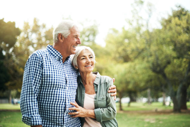 Cherish the people who make your heart smile Shot of an affectionate senior couple spending a day in the park senior couple stock pictures, royalty-free photos & images