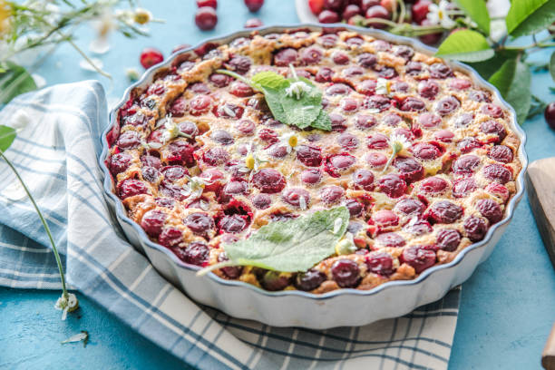 cherry Clafoutis with cherry on a blue  background stock photo