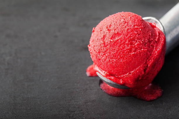 Cherry, raspberry, strawberry, cranberry , red sorbet,scoop, black stone background. Ice cream sorbet. Black stone background. Copy, text space italian culture stock pictures, royalty-free photos & images