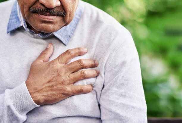 Chest pain can have a variety of causes Closeup shot of a mature man holding his chest in discomfort outdoors chest pain stock pictures, royalty-free photos & images