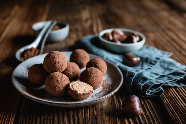 Chestnut truffles coated with cocoa powder minced truffles stock pictures, royalty-free photos & images