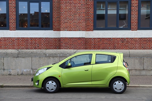 Chevrolet Spark green compact hatchback city car parked in Germany. There were 45.8 million cars registered in Germany (as of 2017).