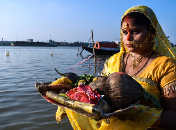 Chhath Festival A women is Worshipping the sun on the occasion of Chhath Festival in Kolkata, India. chhath stock pictures, royalty-free photos & images