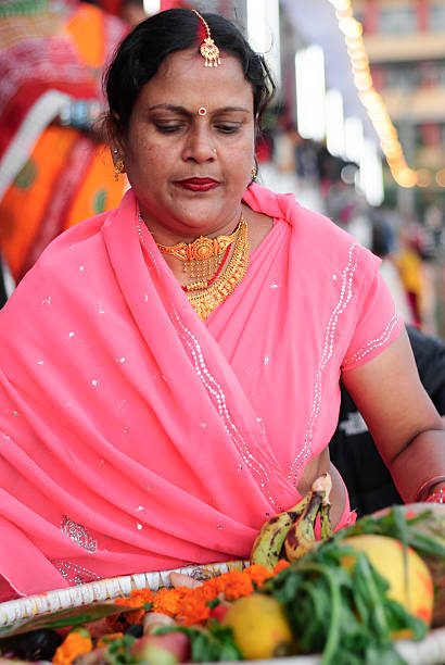 Chhath Festival "Kathmandu, Nepal - November 16, 2007: Madhesi woman presenting offering to the Sun god on the eve of Chhath festival. Chhath is one of the ancient festival of Hindus dedicated to Sun god, in order to promote prosperity, progress and well being." chhath stock pictures, royalty-free photos & images