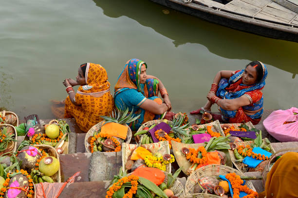 chhath puja at varanasi varanasi india on november 8th 2013:Unidentified Indian women pray and devote for Chhath Puja festival on Ganges river side in Varanasi,India chhath stock pictures, royalty-free photos & images