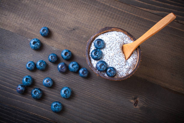 Chia Pudding, blackberry in coconut shell stock photo
