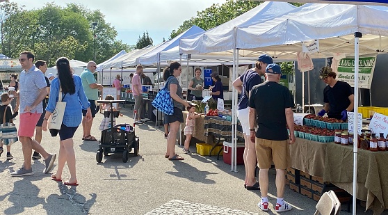 Winnetka, IL, USA - June 12 2021: Farmers Markets in Illinois are open with shoppers and vendors unmasked as the state lifts COVID restrictions.