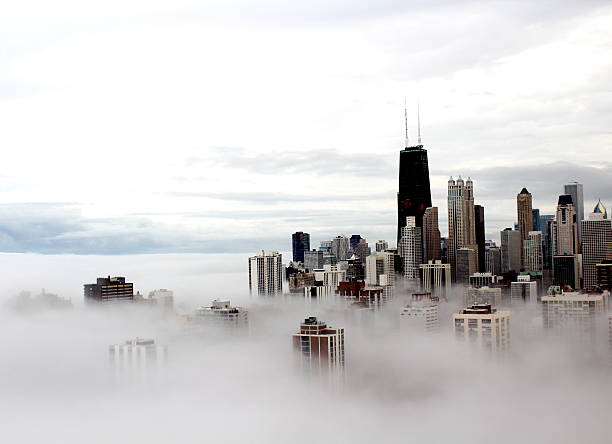 Chicago city buildings in the clouds Taken in March 2012 during a massive fog that covered the city landscape.  high angle view photos stock pictures, royalty-free photos & images