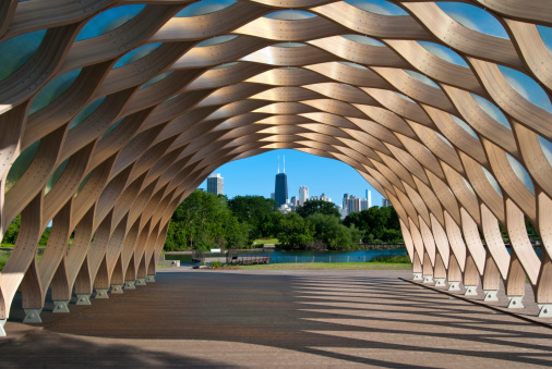 Chicago, Illinois, USA - June 29, 2010: John Hancock building viewed through a public pavilion in the shape of a honeycomb, at the newly opened urban wetlands area at Lincoln Park Zoo.