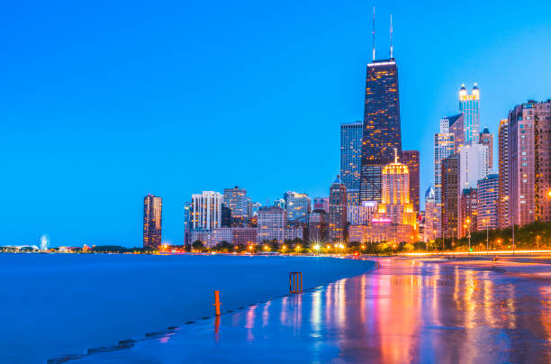 Chicago skyline at sunset with cloudy sky and reflection in water. stock photo