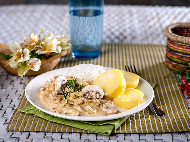 Chicken a La King with rice and potatoes stock photo