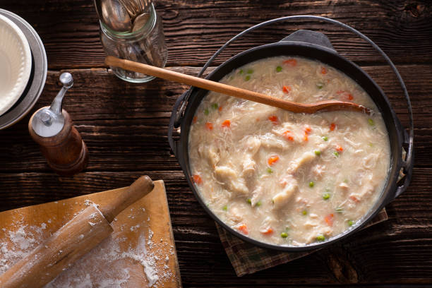 Chicken and Dumplings Cast Iron Dutch Oven full of Chicken and Dumplings chicken dumplings stock pictures, royalty-free photos & images