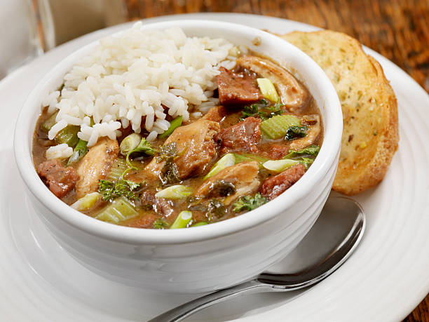 Chicken and Sausage Gumbo Creole Style Chicken  and Sausage Gumbo with white rice and bread- Photographed on Hasselblad H3D2-39mb Camera gumbo stock pictures, royalty-free photos & images