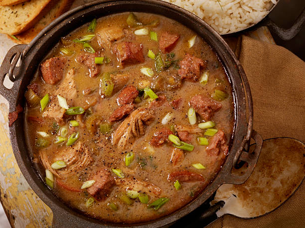 Chicken and Sausage Gumbo Creole Style Chicken  and Sausage Gumbo with white rice and French bread- Photographed on Hasselblad H3D2-39mb Camera gumbo stock pictures, royalty-free photos & images