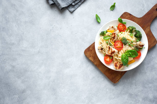 Chicken and Vegetables Pasta Chicken and Vegetables Pasta. Spaghetti pasta with grilled chicken meat, vegetables and basil, top view, copy space. Seasonal pasta primavera recipe. crockery photos stock pictures, royalty-free photos & images