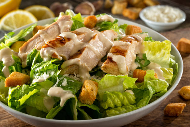 Chicken Caesar Salad A delicious chicken caesar salad with parmesan cheese, dressing and croutons. salad stock pictures, royalty-free photos & images