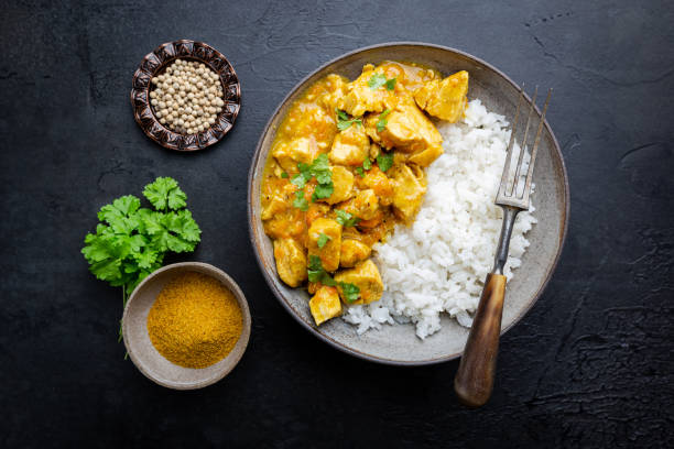 chicken cooked with curry sauce Spicy chicken cooked with curry sauce and rice, top view curry powder stock pictures, royalty-free photos & images