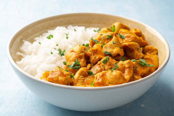 Chicken curry with rice in bowl on concrete background stock photo