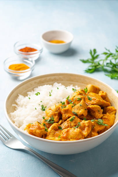 Chicken curry with rice in bowl on concrete background stock photo