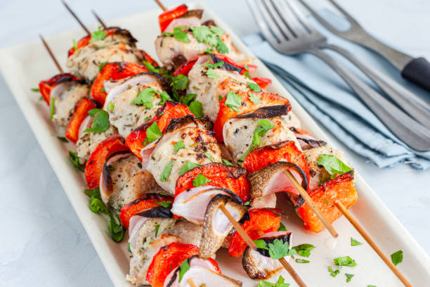 Chicken Kebab on the Skewers on a Platter Close-Up Photo stock photo