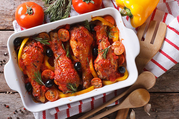 Chicken legs in tomato sauce with olives horizontal top view stock photo