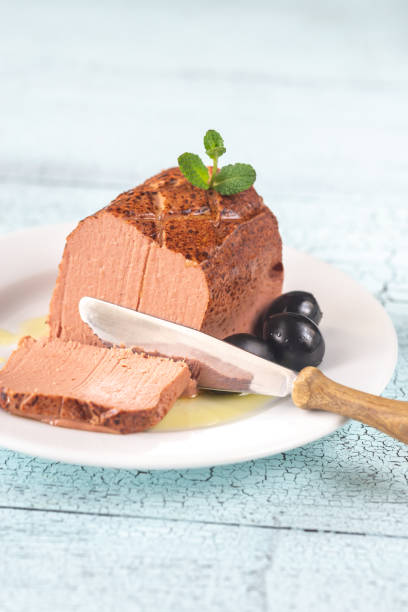 Chicken liver pate on the white plate Chicken liver pate with black olives on the white plate: cross section liver pâté photos stock pictures, royalty-free photos & images