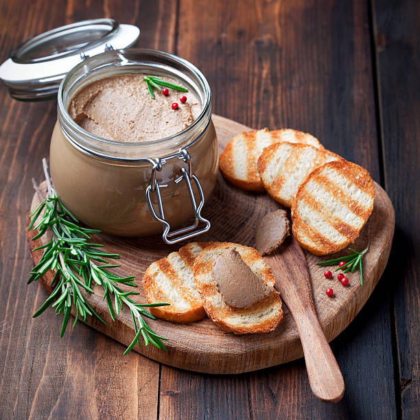 Chicken liver pate Chicken liver pate in jar and on bread, selective focus foie gras photos stock pictures, royalty-free photos & images