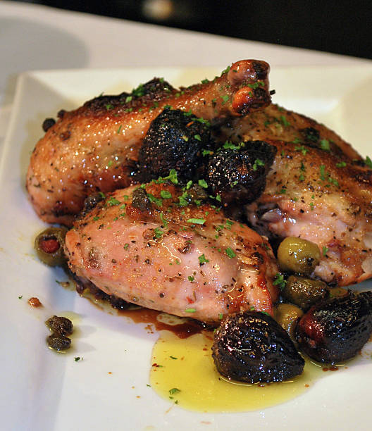 Chicken Marbella Chicken with capers, olive, figs and herbs marbella stock pictures, royalty-free photos & images