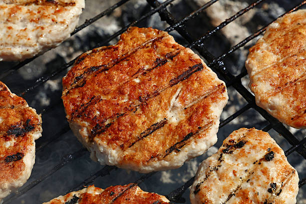 Chicken or turkey burgers for hamburger on grill stock photo